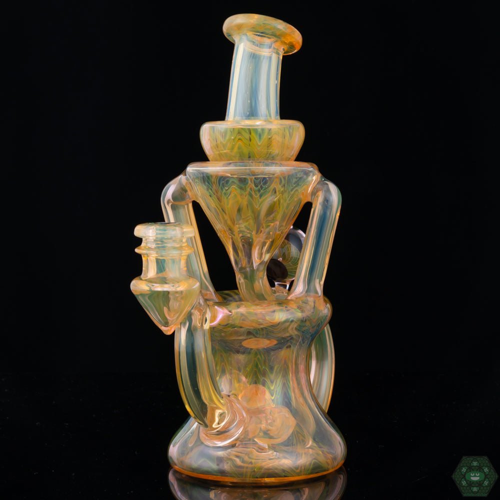 STF Glass Fumed Recycler #3, a unique 10mm handcrafted dab rig featuring dual uptake and a fumed glass finish for a vibrant color shift effect, offering smooth pulls and a standout addition to any glass collection.


